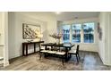 Bright dining area with large windows and a dark wood table with bench seating at 2007 Opulent Oaks Ln # 24, Durham, NC 27713