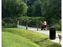 Scenic view of Personal pushing stroller along bridge-accented walking path at 214 Drayton Hall Ln, Sanford, NC 27330