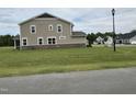 Lovely two-story home features a stone accent and a spacious lawn at 224 Bering Cir, Angier, NC 27501