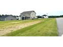 Two-story home boasts a screened-in porch and generous backyard space at 224 Bering Cir, Angier, NC 27501