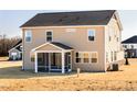 Well-maintained rear exterior with a screened porch and neutral siding at 224 Bering Cir, Angier, NC 27501