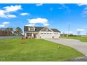 Charming home featuring a three-car garage, stone accents, well manicured lawn, and a large driveway at 32 Boyce Ct, Sanford, NC 27332