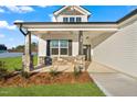 Inviting home featuring stone pillar accents and a charming front porch at 32 Boyce Ct, Sanford, NC 27332