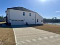 Spacious two-car garage and backyard pond at 225 Bering Cir, Angier, NC 27501