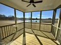 Enclosed sunroom with ceiling fan and scenic backyard view at 225 Bering Cir, Angier, NC 27501