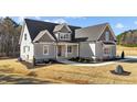 Beautifully designed home with a gray exterior, attractive roofline and manicured front yard at 25 Firefly Ln, Youngsville, NC 27596