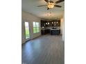Spacious open-concept living room with hardwood floors leading to a modern kitchen with stainless steel appliances at 238 Plains Dr # 313, Burlington, NC 27217