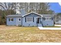 Newly renovated gray brick ranch home with modern gray accents and a long driveway at 4713 Zebulon Rd, Zebulon, NC 27597