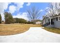 Large front yard with long driveway and mature trees at 4713 Zebulon Rd, Zebulon, NC 27597