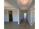 Open entryway featuring light hardwood floors, white trim, and views of adjoining rooms at 111 Demascus Way # 021, Four Oaks, NC 27524