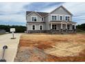 Two-story home with stone accents and large windows on a large lot at 111 Demascus Way # 021, Four Oaks, NC 27524