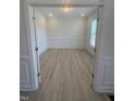 Clean, well-lit office featuring white trim, light hardwood floors, and a large window at 111 Demascus Way # 021, Four Oaks, NC 27524