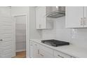 Bright, contemporary kitchen featuring white cabinetry, subway tile backsplash, and gas cooktop at 9216 Leaning Post Rd # 447, Wake Forest, NC 27587