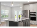 Modern kitchen with stainless steel appliances, quartz countertops, and a central island at 9216 Leaning Post Rd # 447, Wake Forest, NC 27587
