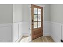 View of entryway featuring a glass panel door and wainscoting at 120 W Weatherford Dr, Angier, NC 27501