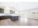 Spacious kitchen with an island, stainless steel appliances, and light wood flooring at 207 Wildwood Ln, Graham, NC 27253