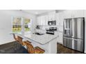 Bright kitchen features an island with granite countertops and stainless steel appliances at 114 Hickory Grove Dr, Sanford, NC 27330