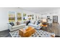 Open-concept living room with dark wood floors and lots of natural light at 114 Hickory Grove Dr, Sanford, NC 27330