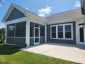 This patio features a screened-in porch, a concrete slab, and an attractive blue and white color scheme at 1230 Linkwood, Homesite 44, Fuquay Varina, NC 27526