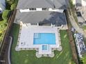 Beautiful backyard featuring a swimming pool, hot tub, fire pit, and lush landscaping at 662 Manchester Dr, Raleigh, NC 27609