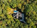 Breathtaking aerial shot of an estate nestled among lush greenery, showcasing a serene and private setting at 3105 Cone Manor Ln, Raleigh, NC 27613