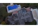 A bird's eye view reveals the extensive roofline, pool area, and driveway of this unique estate at 3105 Cone Manor Ln, Raleigh, NC 27613