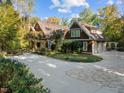 Charming home featuring cedar shake siding, dormer windows, and a circular driveway at 3105 Cone Manor Ln, Raleigh, NC 27613