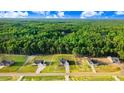 Aerial view showcasing a home with a yellow property outline in a densely wooded area, highlighting its private lot at 9314 Turkey Way, Middlesex, NC 27557