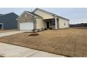 Newly built one-story home with a two-car garage and a grassy yard at 7290 Pilatus Ave, Spring Hope, NC 27882