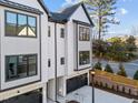 Two modern townhomes with black-trimmed windows, dark garage doors, and a well-kept front yard at 811 Maple Berry Ln # 101, Raleigh, NC 27607