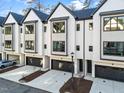 Modern townhomes feature attached garages, neutral palette, black trim, and minimalist landscaping at 811 Maple Berry Ln # 102, Raleigh, NC 27607