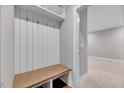 Bright mudroom features a built-in bench with coat hooks and storage shelves for organization at 811 Maple Berry Ln # 105, Raleigh, NC 27607