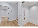 Hallway area with an elevator, access to stairs, and wood flooring at 811 Maple Berry Ln # 106, Raleigh, NC 27607