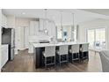 Modern kitchen with a large center island, pendant lighting, stainless appliances, and an open floor plan at 8841 Tartan Clan Dr, Willow Springs, NC 27592