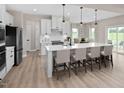 Bright kitchen featuring a spacious island with barstool seating, stainless steel appliances and an eat-in kitchen at 8841 Tartan Clan Dr, Willow Springs, NC 27592