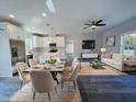 Open-concept living room with a modern kitchen, dining area, and comfortable seating arrangement at 2710 - B Mansfield Ave, Durham, NC 27703