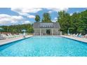 Community pool with ample seating and shaded area for relaxing and enjoying the outdoors at 628 Dorado Rd, Wendell, NC 27591