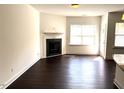Spacious living room with a fireplace and hardwood floors, providing a clean and bright living space at 140 Token House Rd, Durham, NC 27703