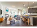 Bright living room featuring a modern fireplace and an open floorplan concept with stylish kitchen at 140 Token House Rd, Durham, NC 27703