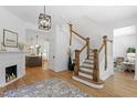 Elegant foyer featuring hardwood floors, staircase, and modern light fixture at 215 E Cabarrus St, Raleigh, NC 27601
