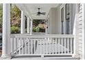 Classic covered front porch with white columns and ceiling fan at 215 E Cabarrus St, Raleigh, NC 27601