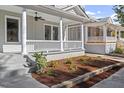 Charming landscaped front yard of a gray two-story home with classic architectural details at 215 E Cabarrus St, Raleigh, NC 27601