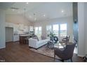 Open-concept living room with a fireplace, island kitchen, and lots of natural light at 239 Harvester Rd, Angier, NC 27501