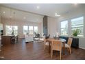 Bright living room with hardwood floors, multiple windows, and a modern fireplace feature wall at 239 Harvester Rd, Angier, NC 27501