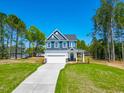 Charming two-story home with manicured front lawn and long driveway at 121 Plainfield Ln # 134, Lillington, NC 27546