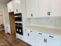 Modern kitchen features white cabinets, stainless steel appliances, and quartz countertops at 33 Macy Cir, Wendell, NC 27591