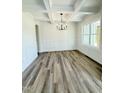 Bright dining room featuring hardwood floors, large windows, wainscoting and modern chandelier at 40 Sunrise Ct, Spring Hope, NC 27882