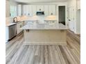Charming kitchen featuring white cabinets, granite countertops, an island and stainless steel appliances at 40 Sunrise Ct, Spring Hope, NC 27882