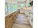 Spacious kitchen featuring light wood cabinets, granite countertops, white cabinets and subway tile back splash at 40 Sunrise Ct, Spring Hope, NC 27882