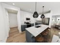 Modern kitchen with island, stainless steel appliances, and shaker cabinets at 3929 Willow Gate Way, Raleigh, NC 27604